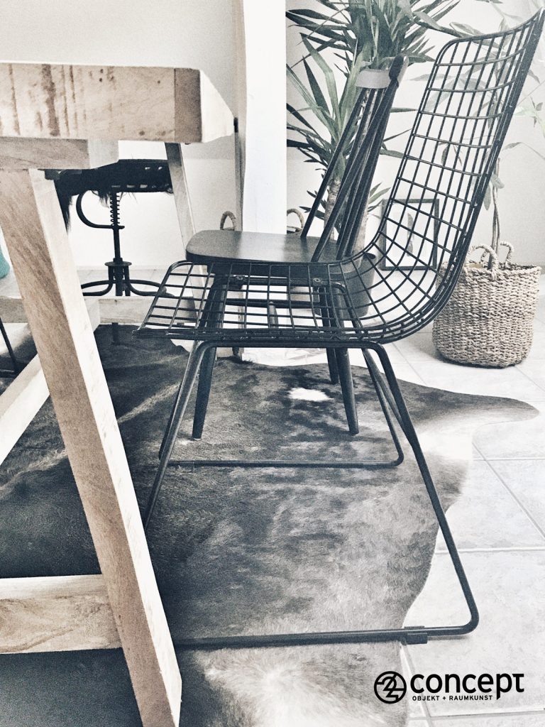 skandinavischer Stuhl aus Metall auf dem Fellteppich